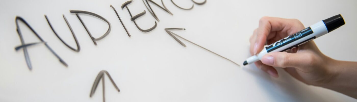 Photo by Melanie Deziel person writing on white paper